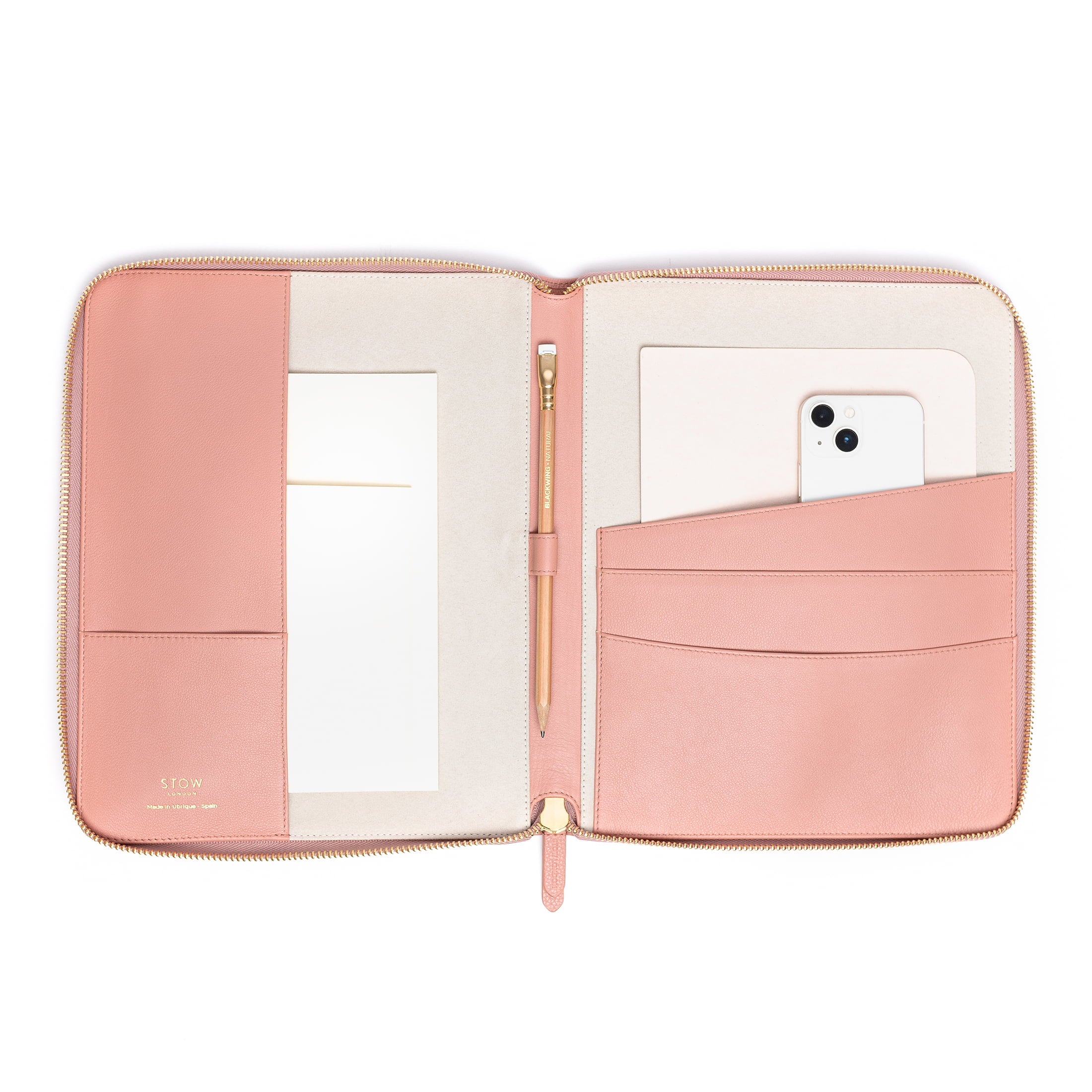 STOW London World Class Folio in Hazy Blush leather, open with accessories placed inside.