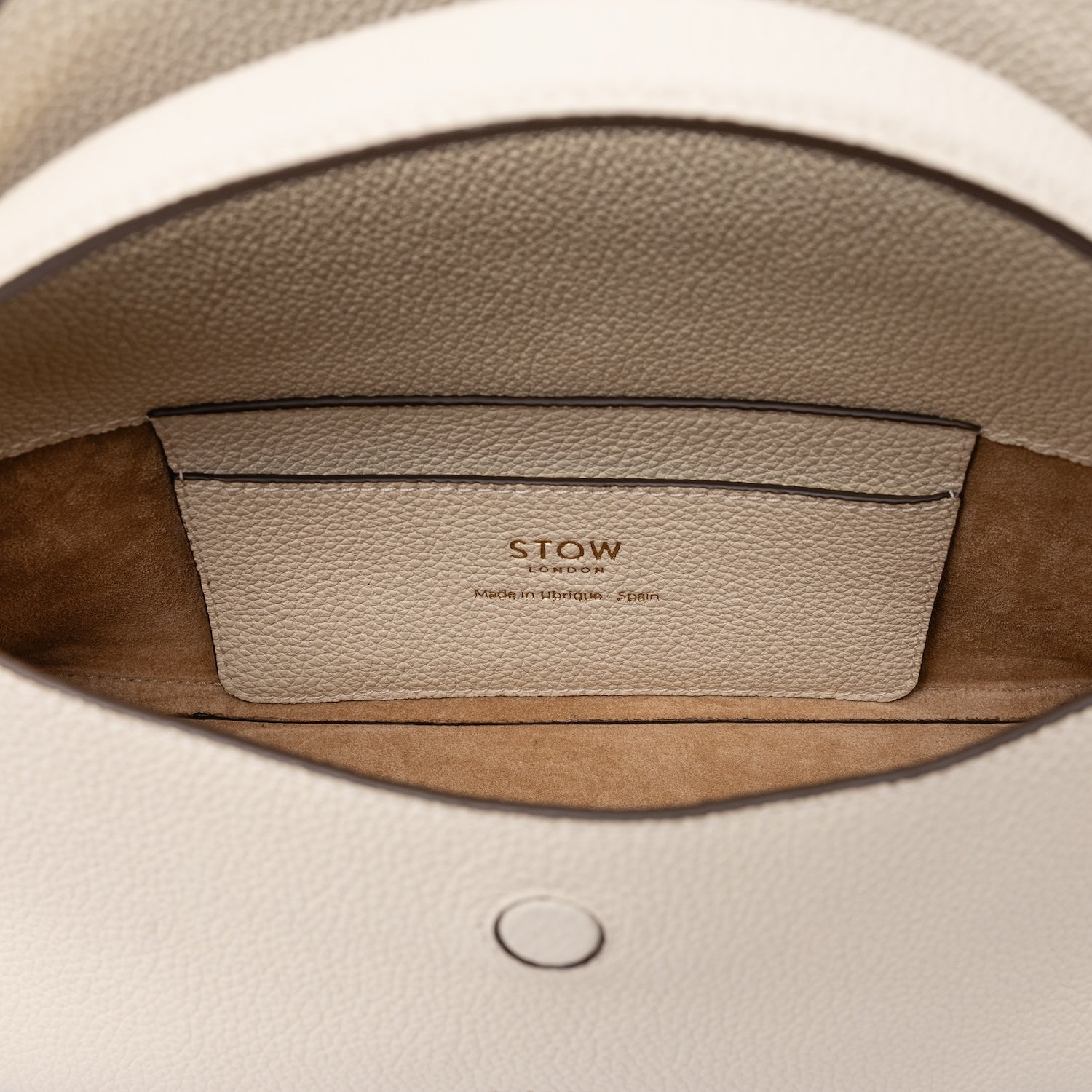 Close up of the suede interior of STOW London's Mini East West in Spring Moon leather featuring the internal slip pocket