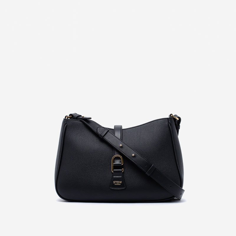 STOW London's Beth bag and detachable crossbody strap in Black leather featuring gold stainless steel hardware on a white background