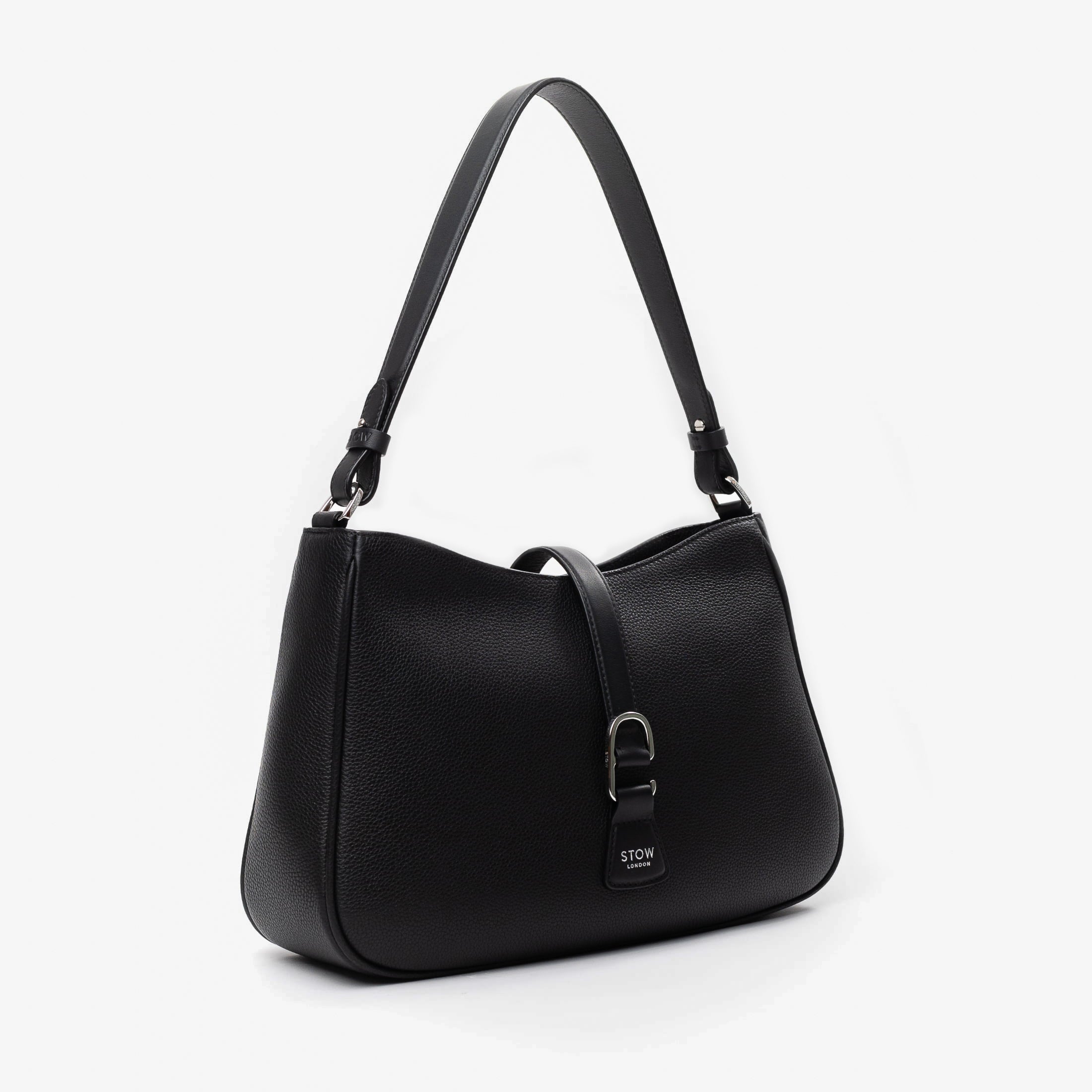 Off-axis view of STOW London's Beth bag in Black pebbled and smooth leather featuring silver stainless steel hardware and clip on a white background