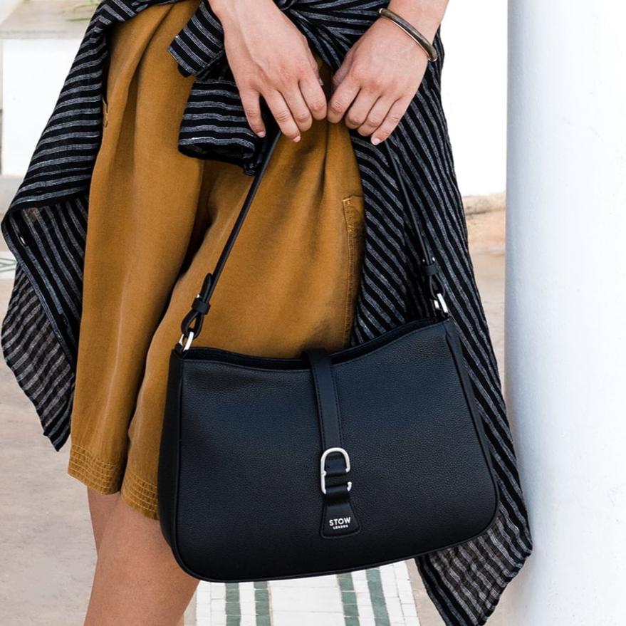 STOW London Beth Shoulder bag in Black leather carried by model in courtyard in Tangiers