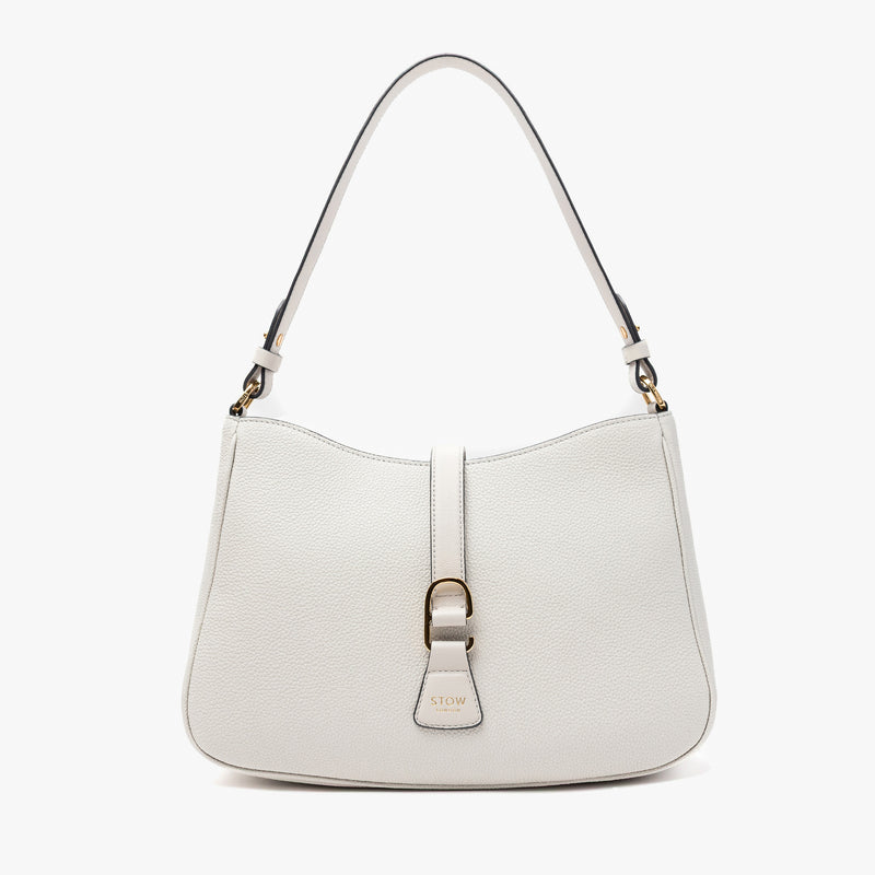 STOW London's Beth bag in Cloud Grey pebbled and smooth leather featuring gold-coated stainless steel hardware and clip on a white background