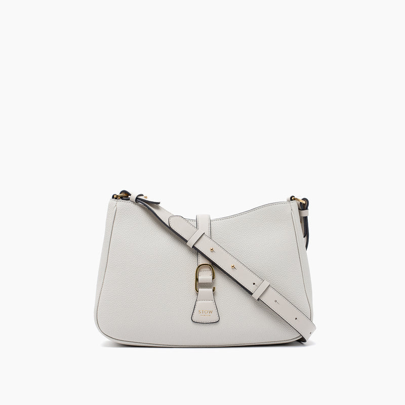STOW London's Beth bag and detachable crossbody strap in Cloud Grey leather featuring gold stainless steel hardware on a white background