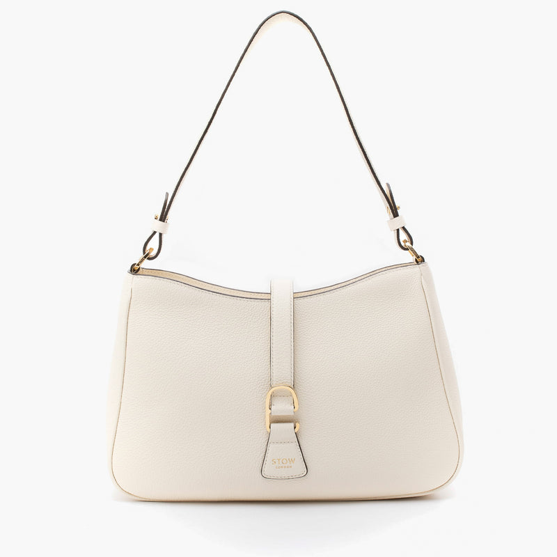 STOW London's Beth bag in Spring Moon pebbled and smooth leather featuring gold-coated stainless steel hardware and clip on a white background