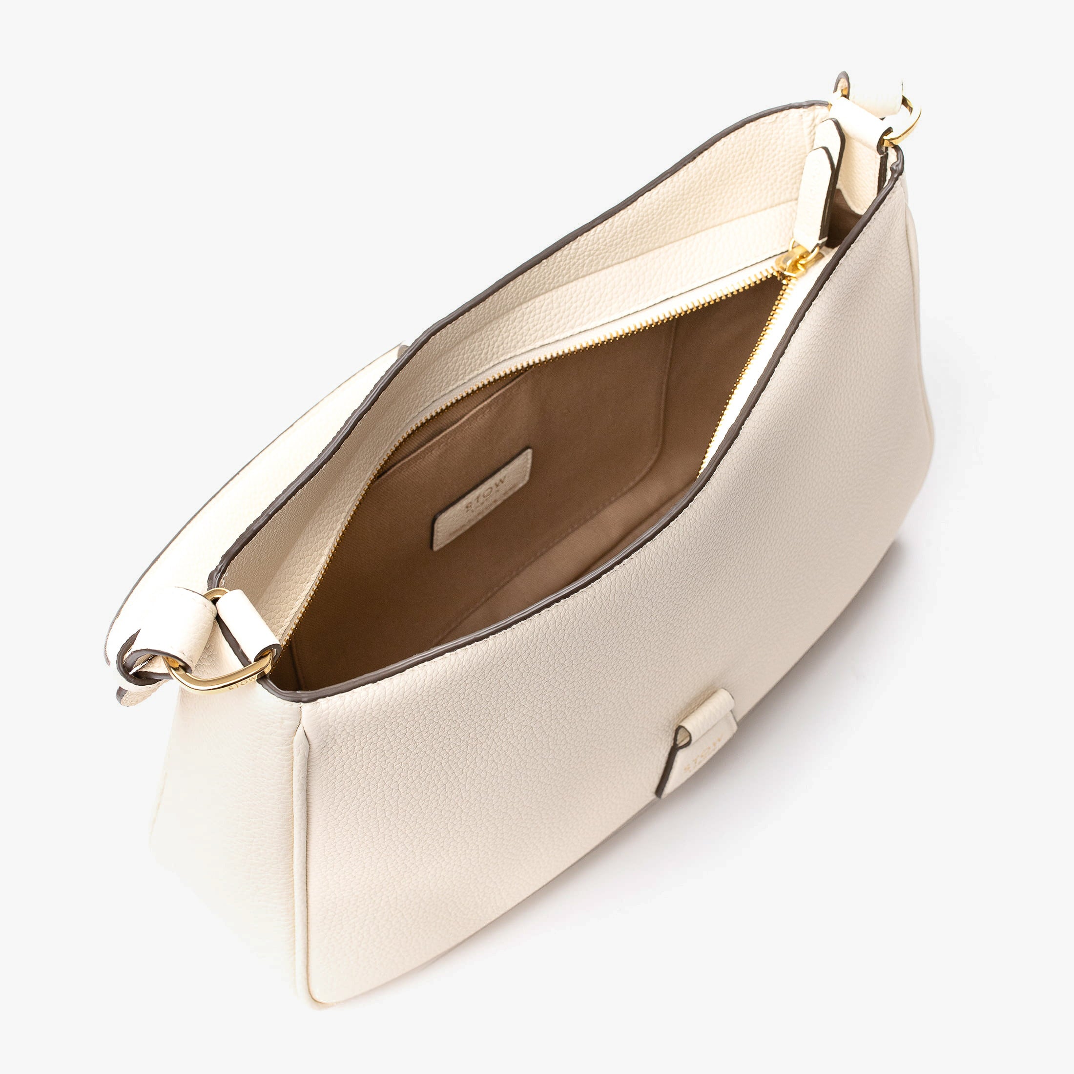 Top angled view of STOW London's Beth bag in Spring Moon pebbled and smooth leather with zipper open showing the interior cotton lining and card holder pocket, featuring gold-coated stainless steel hardware on a white background