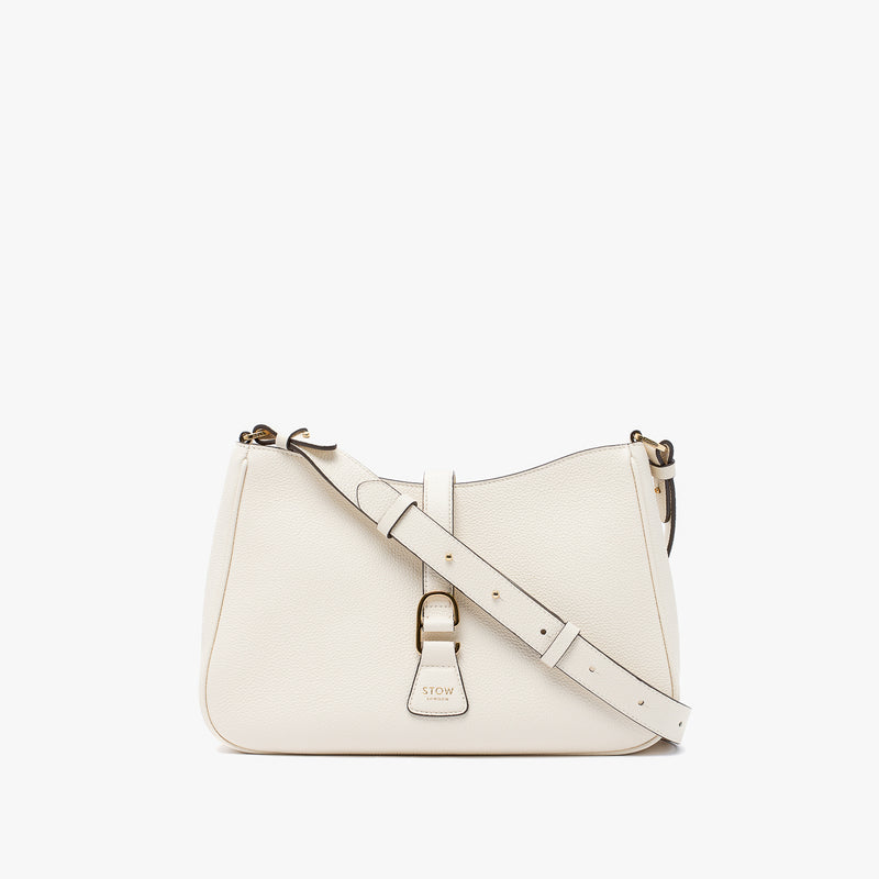 STOW London's Beth bag and detachable crossbody strap in Spring Moon leather featuring gold stainless steel hardware on a white background