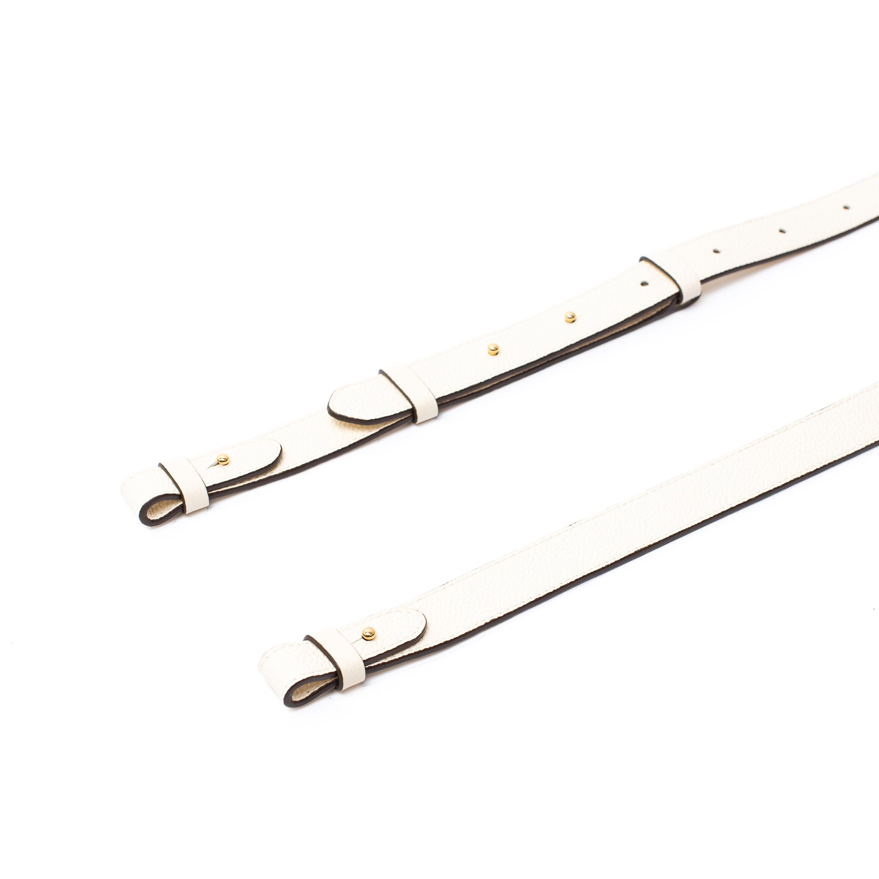 Close up of STOW London's detachable crossbody strap for the Beth bag in Spring Moon leather featuring gold stainless steel hardware on a white background