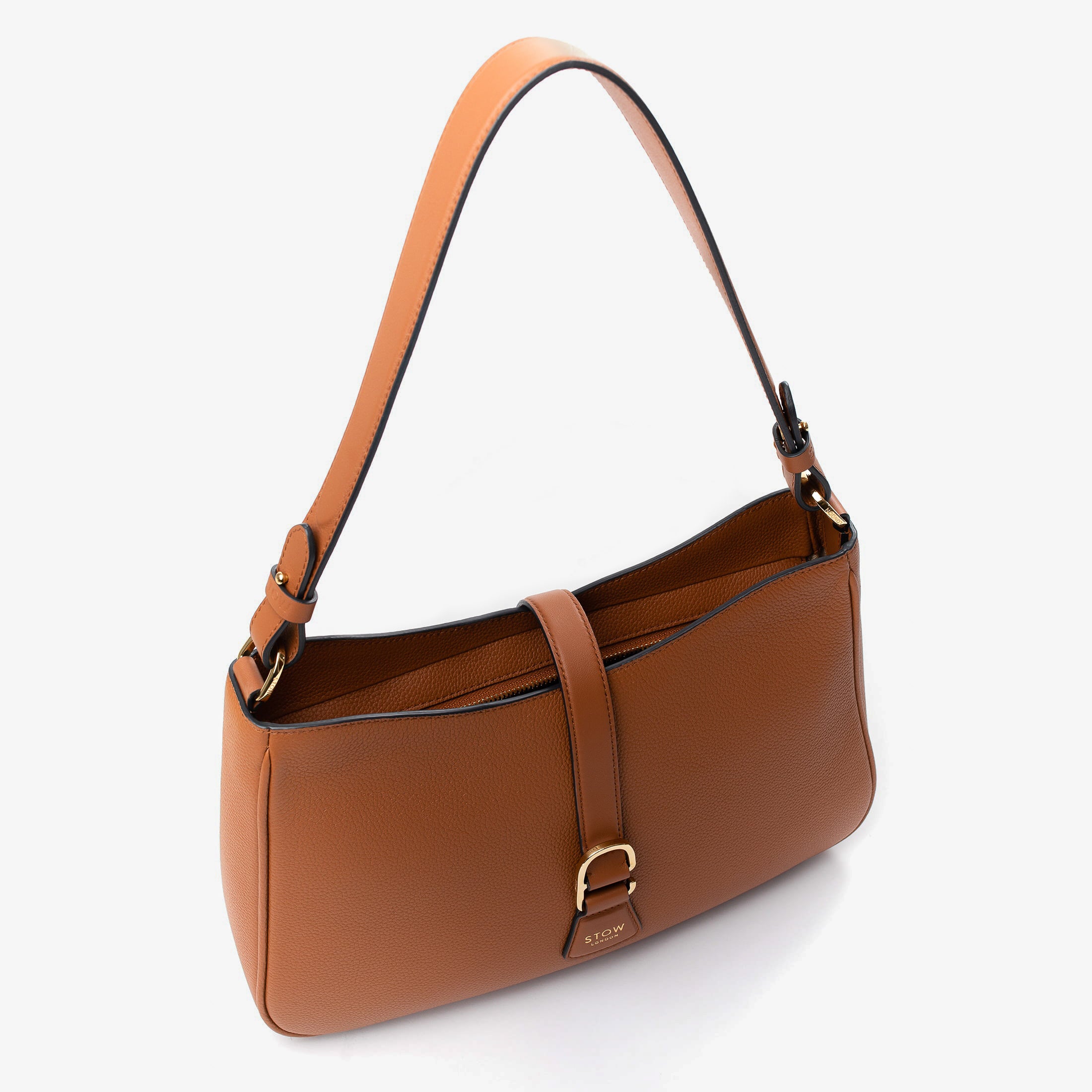 Top angled view of STOW London's Beth bag in Earth Tan pebbled and smooth leather with zipper open showing the interior cotton lining and card holder pocket, featuring gold-coated stainless steel hardware on a white background