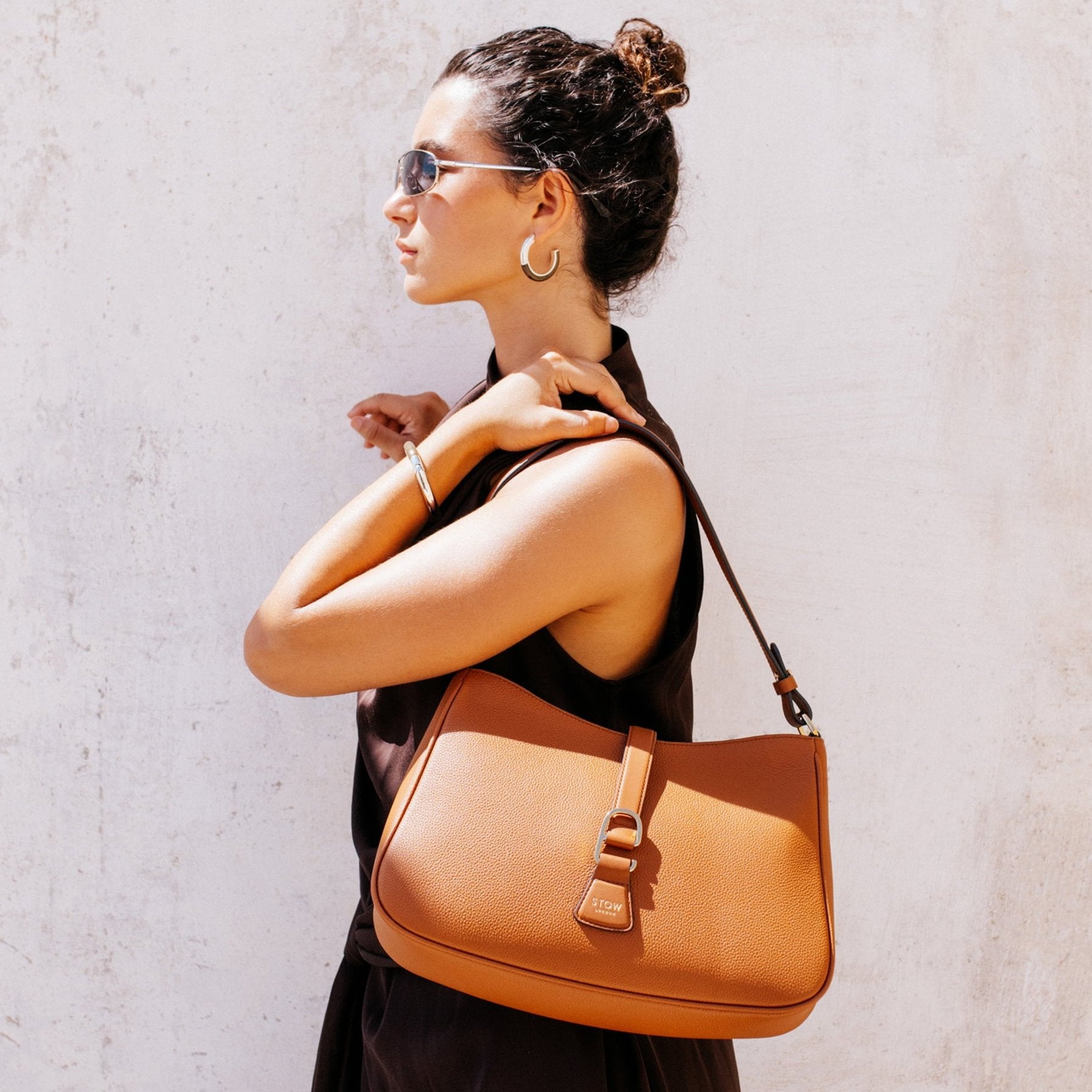 STOW London Beth Shoulder bag in Earth Tan leather carried by model in Tangiers