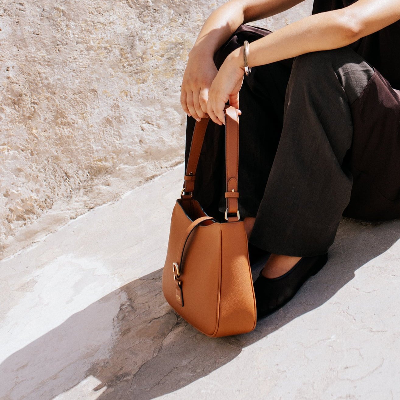 STOW London Beth Shoulder bag in Earth Tan leather carried by model in Tangiers