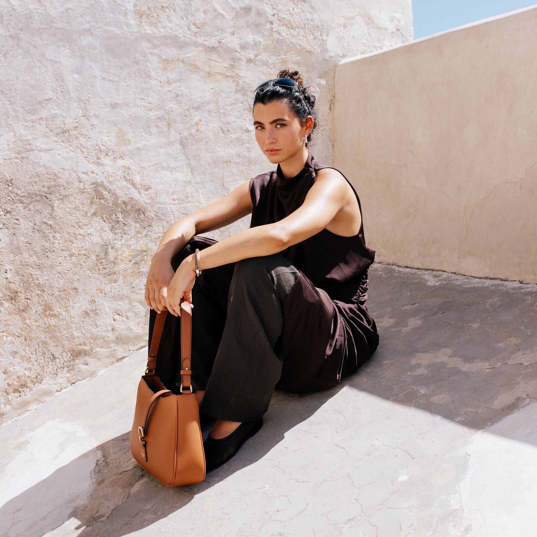 STOW London Beth Shoulder bag in Earth Tan leather carried by model in Tangiers