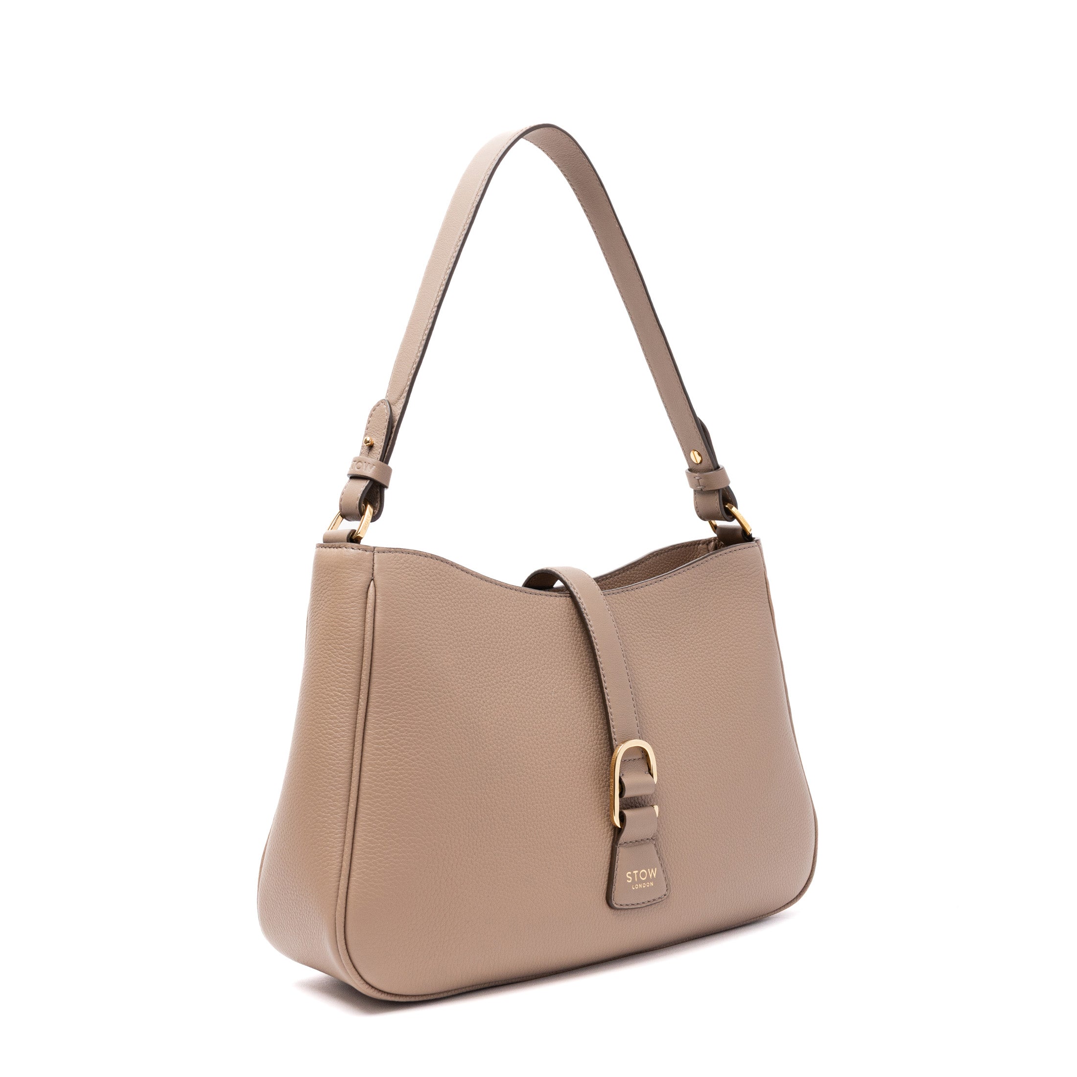 Off-axis view of STOW London's Beth bag in Warm Taupe pebbled and smooth leather featuring gold-coated stainless steel hardware and clip on a white background