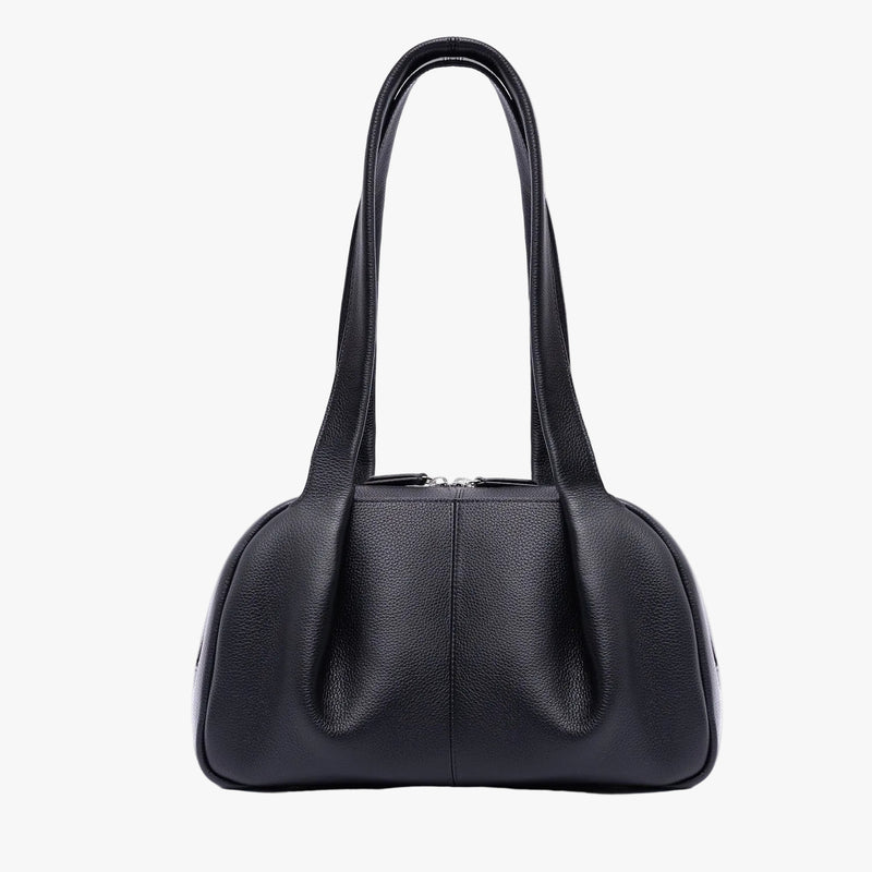 STOW London's Bowling bag in Black pebbled leather featuring the pleated front panel and silver stainless steel hardware on a light grey background