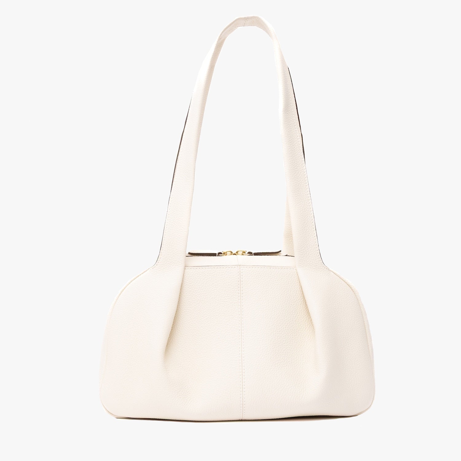 STOW London's Bowling bag in Spring Moon pebbled leather featuring the pleated front panel and gold-coated stainless steel hardware on a light grey background