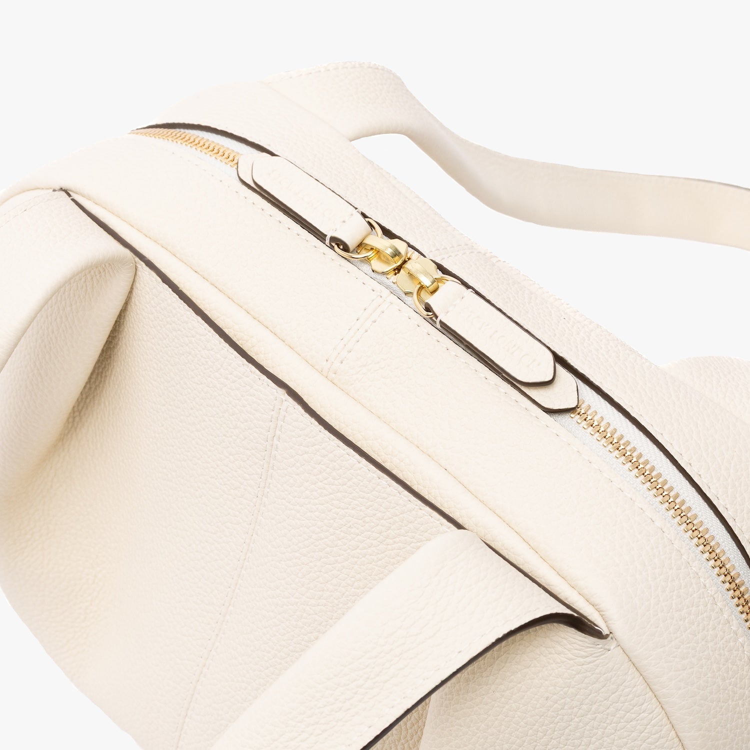 Close up of the zip top closure on STOW London's Bowling bag in Spring Moon pebbled leather featuring the front slip pocket and gold-coated stainless steel hardware on a light grey background