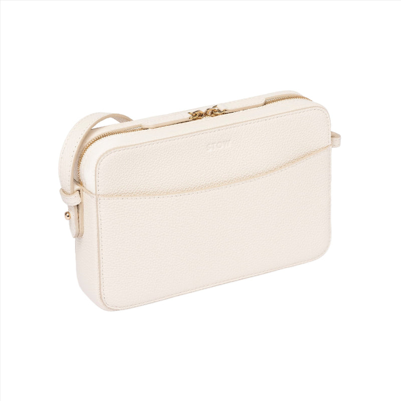 Spring Moon cream leather Camera Bag by STOW, studio image showing bag diagonally with crossbody strap.
