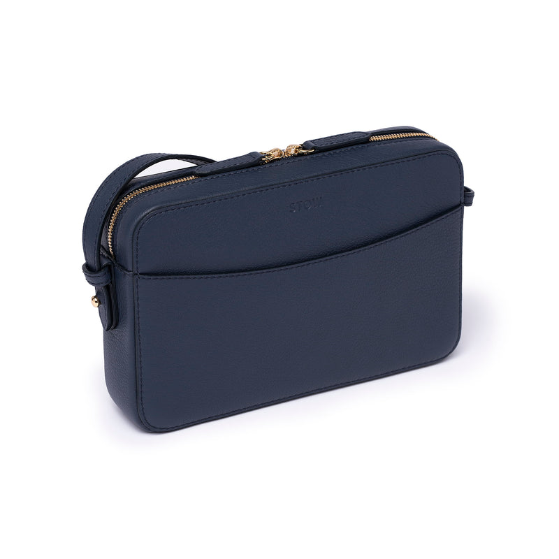 Navy leather Camera Bag by STOW, studio image showing bag diagonally with crossbody strap.