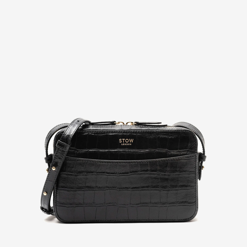 STOW London's Camera bag in Black Embossed Croc leather with detachable crossbody strap featuring gold-coated stainless steel hardware on a white background