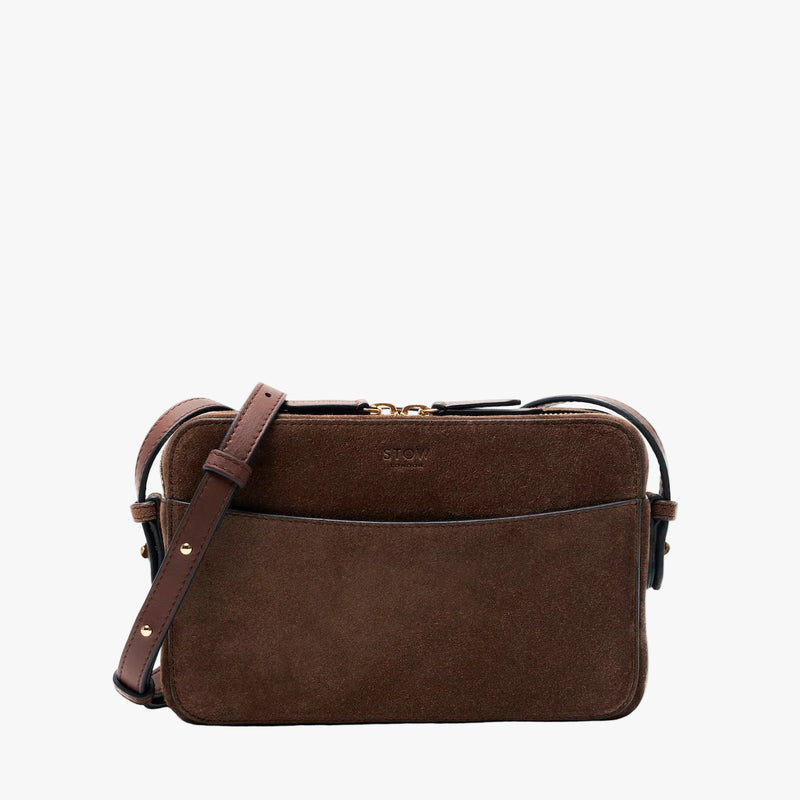 STOW London's Camera bag in Chocolate Suede leather with detachable crossbody strap featuring gold-coated stainless steel hardware on a light grey background