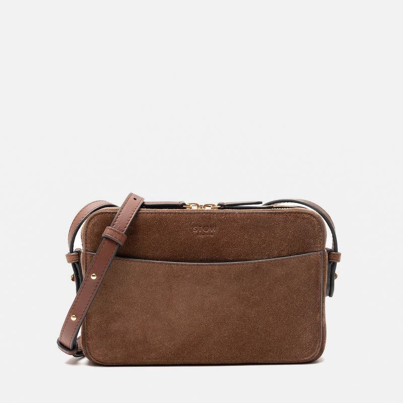 STOW London's Camera bag in Chocolate Suede leather with detachable crossbody strap featuring gold-coated stainless steel hardware on a white background