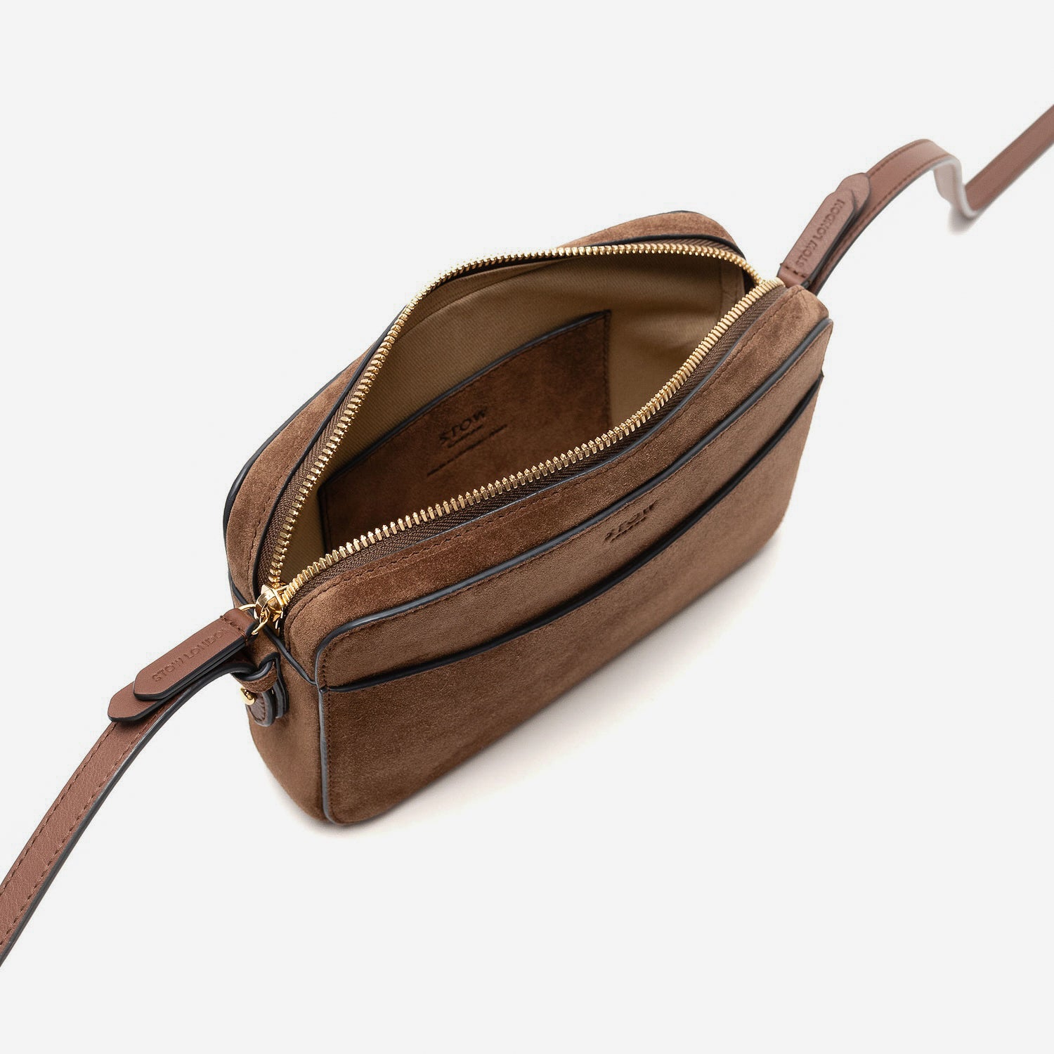 Top view of STOW London's Camera bag in Chocolate Suede leather with zip open showing the bag's interior featuring gold-coated stainless steel hardware on a white background