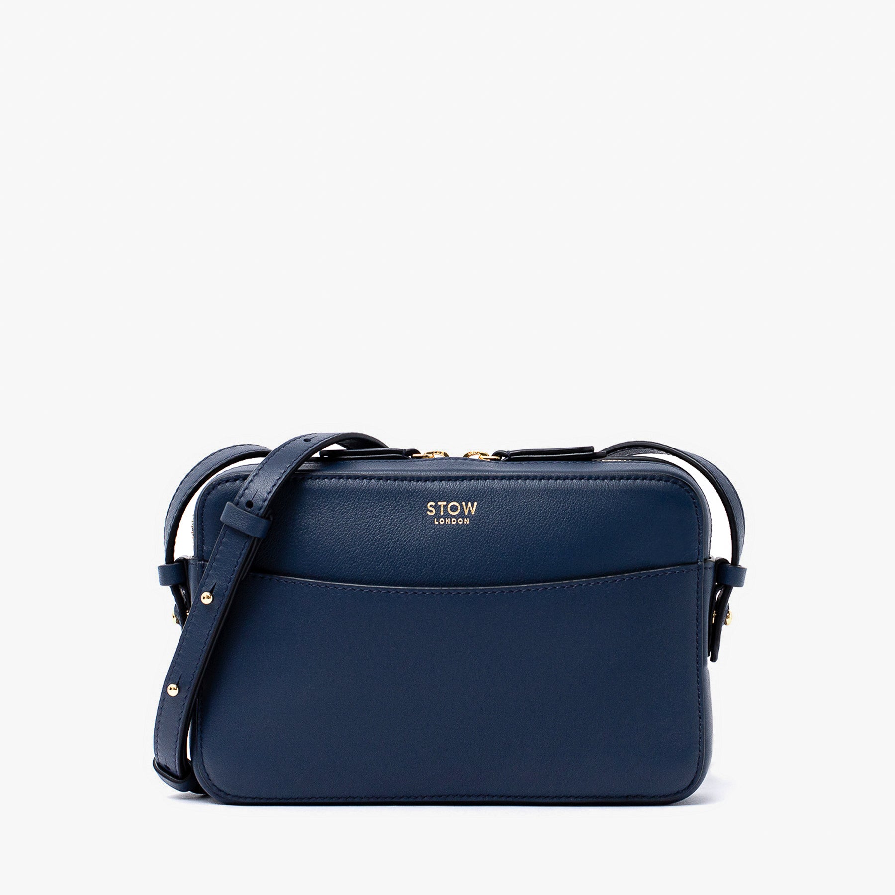 STOW London's Camera bag in Navy smooth leather with detachable crossbody strap featuring gold-coated stainless steel hardware on a white background