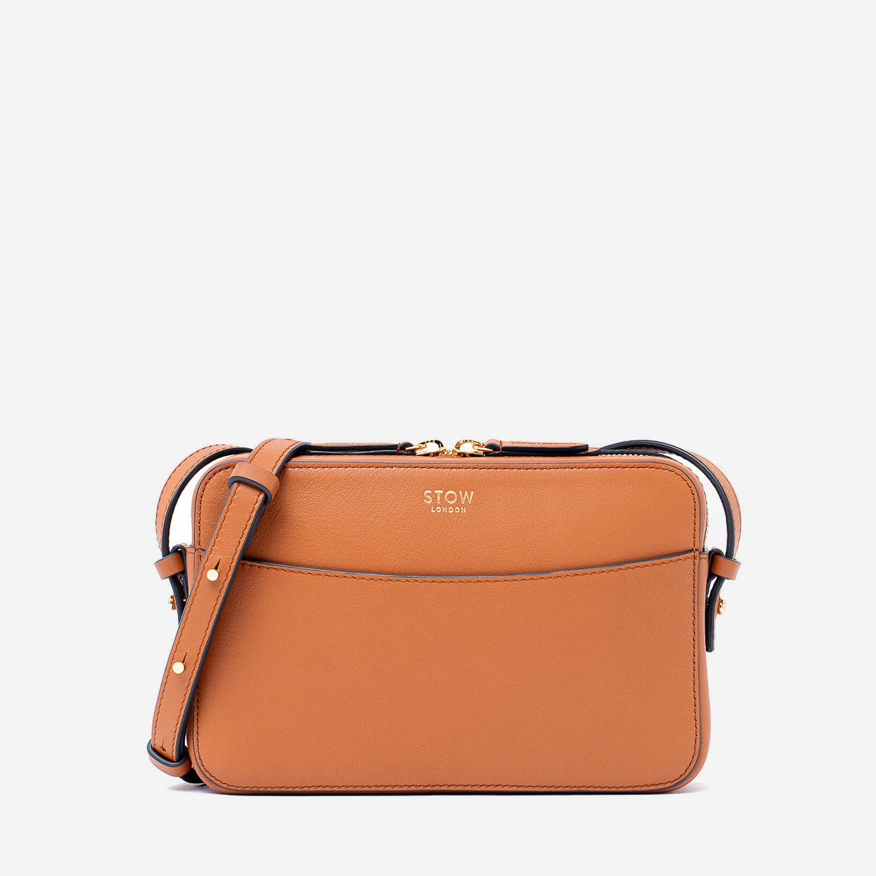 STOW London's Camera bag in Earth Tan smooth leather with detachable crossbody strap featuring gold-coated stainless steel hardware on a white background
