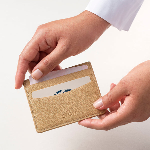STOW Leather Cardholder in Almond colour being held by model