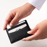 STOW Leather Cardholder in Black colour being held by model.