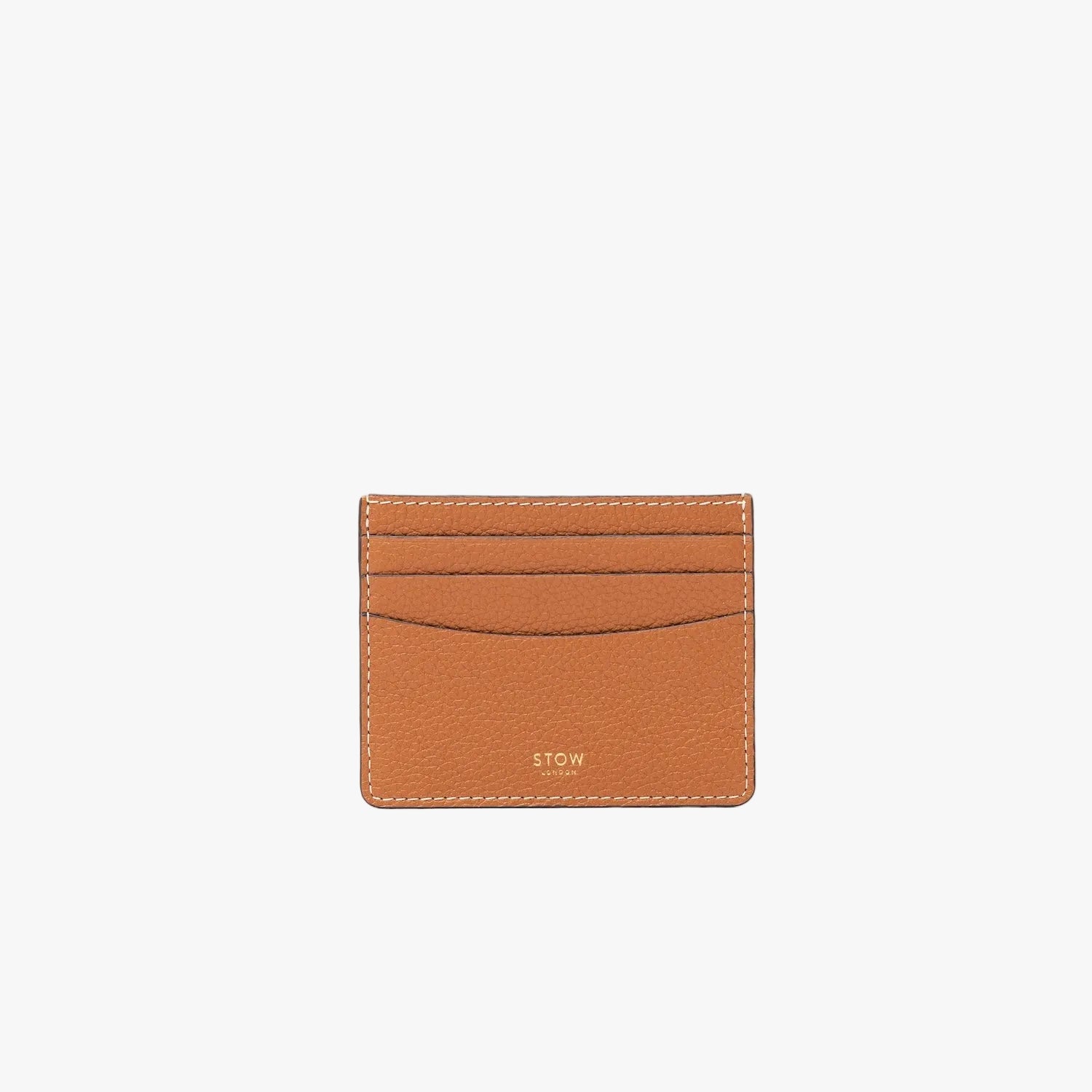 STOW London's Cardholder in Earth Tan pebbled leather on a light grey background featuring a fine gold embossed logo on the front bottom. 
