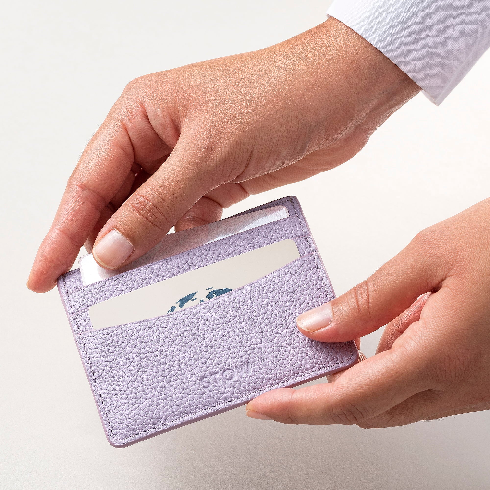 STOW Leather Cardholder in Wild Lavender colour being held by model.
