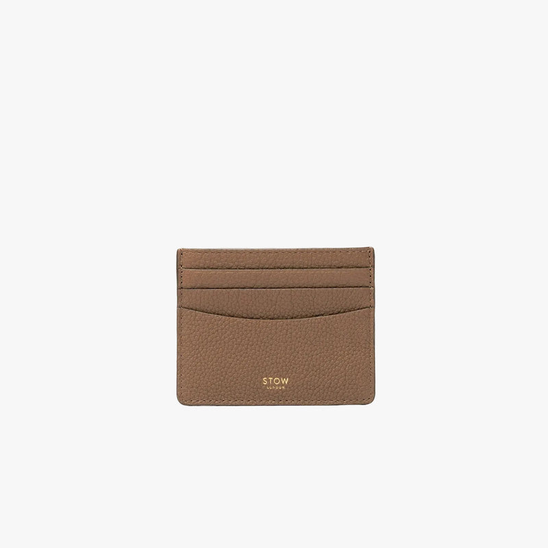 STOW London's Cardholder in Mocha pebbled leather on a light grey background featuring a fine gold embossed logo on the front bottom. 