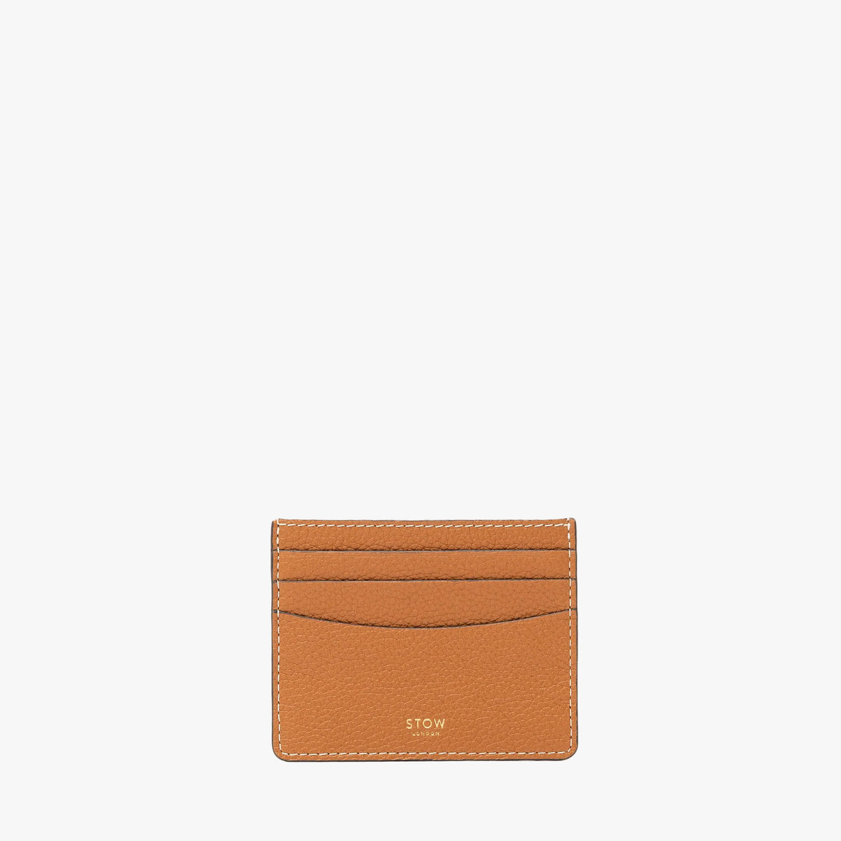 STOW London's Cardholder in Earth Tan pebbled leather on a light grey background featuring a fine gold embossed logo on the front bottom. 