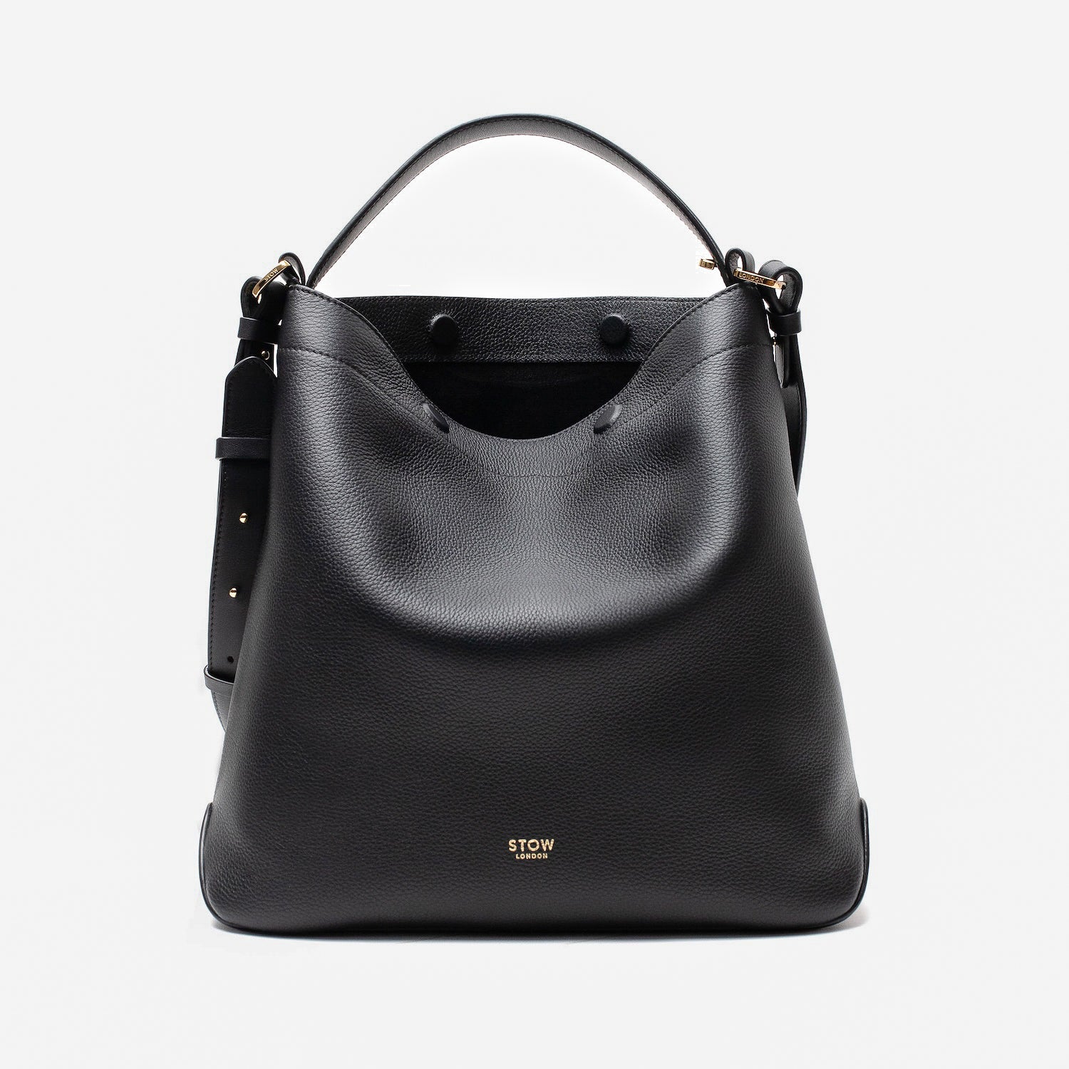 Stow London's Curve bag in Black pebbled leather with magnets open showing the black suede interior lining featuring gold-coated stainless steel hardware on a light grey background