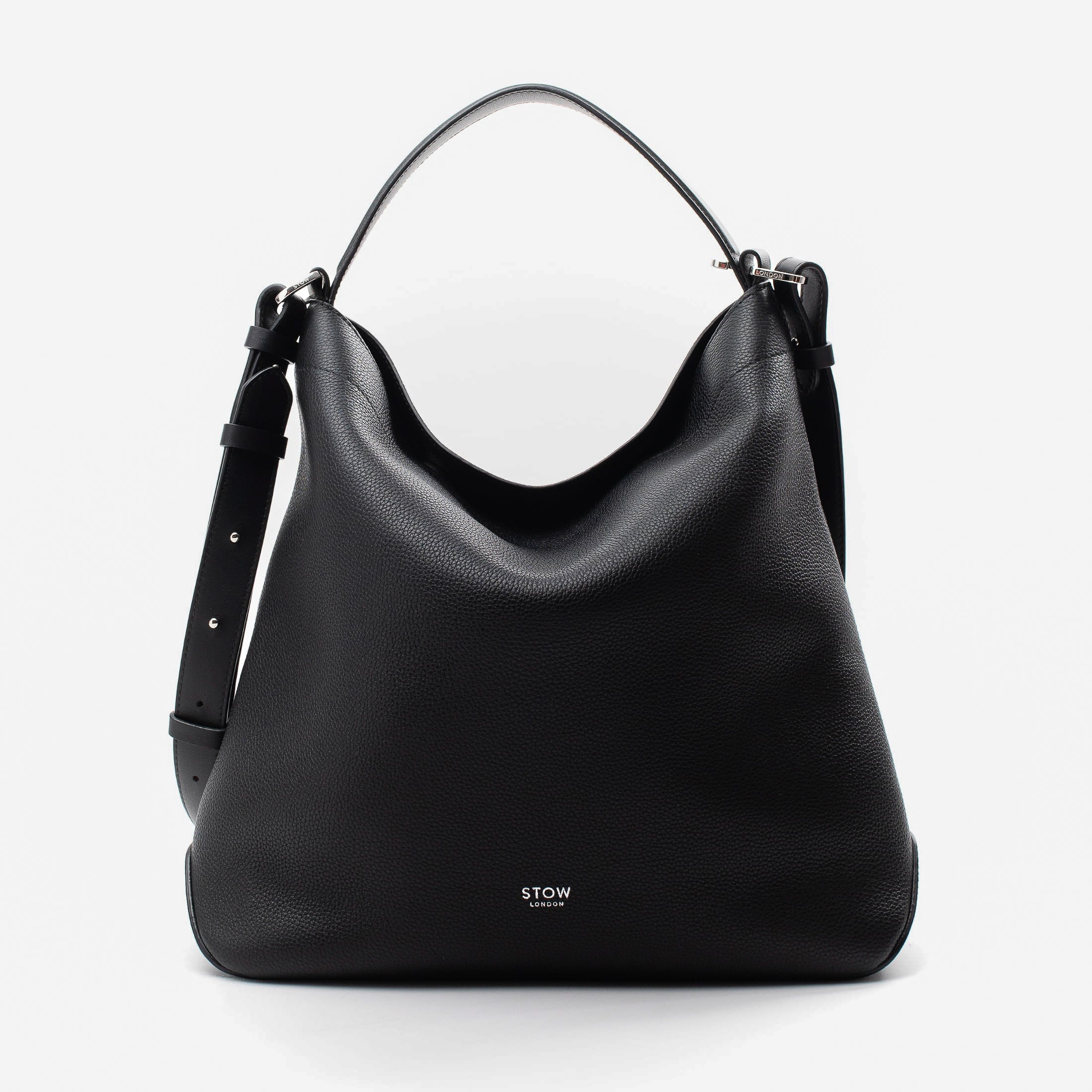 Stow London's Curve bag in Black pebbled leather featuring silver stainless steel hardware on a light grey background