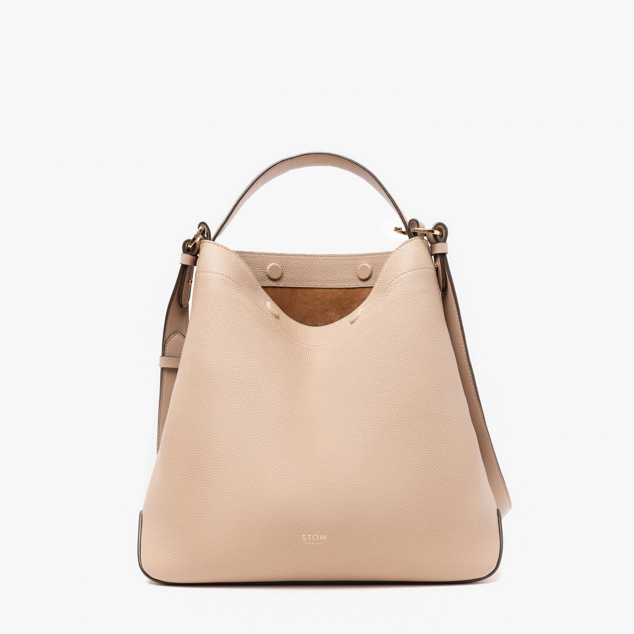 STOW London's Curve bag in Camel pebbled leather with magnets open showing the suede interior lining featuring gold stainless steel hardware on a light grey background