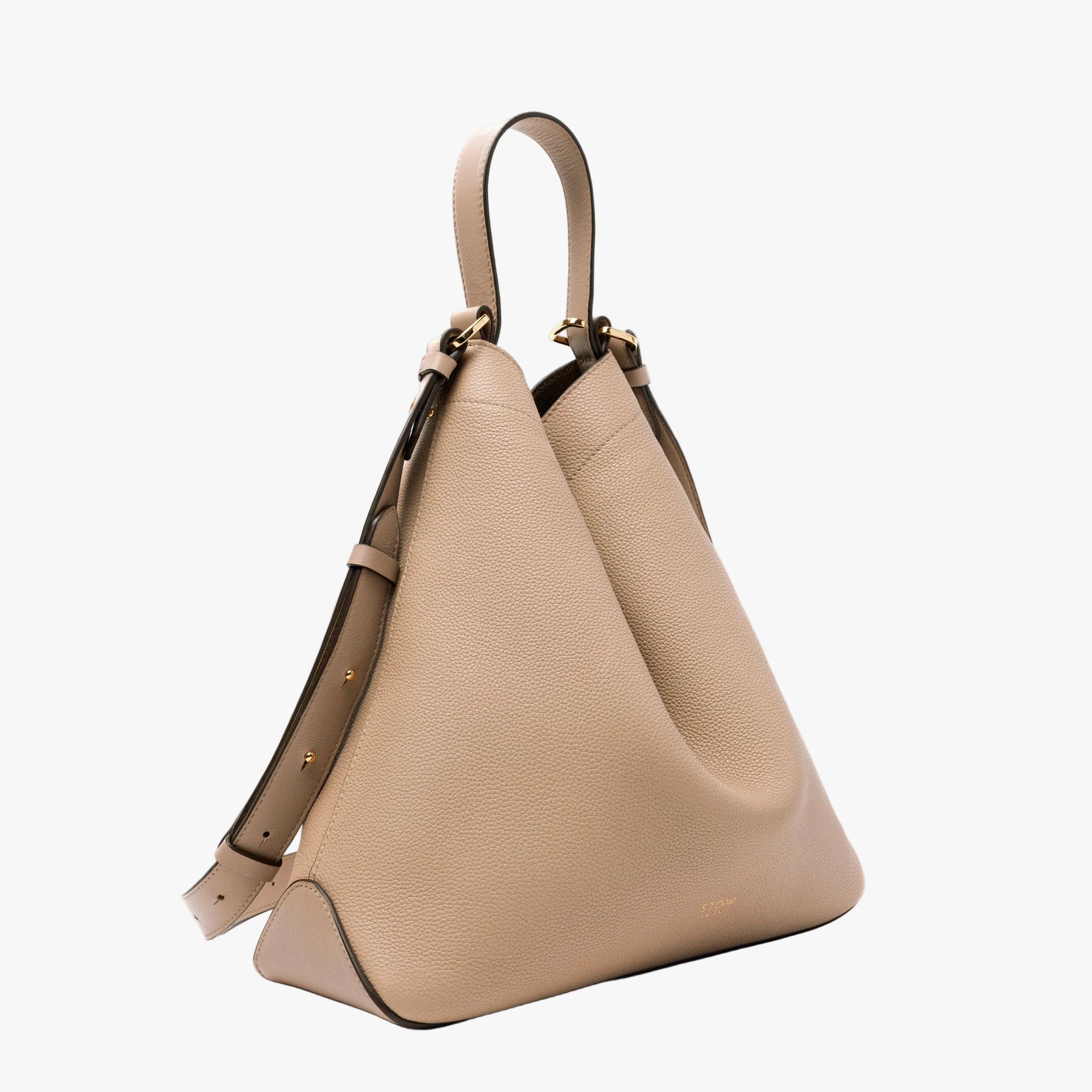 Off-axis view of STOW London's Curve bag in Camel pebbled leather featuring gold-coated stainless steel hardware on a light grey background