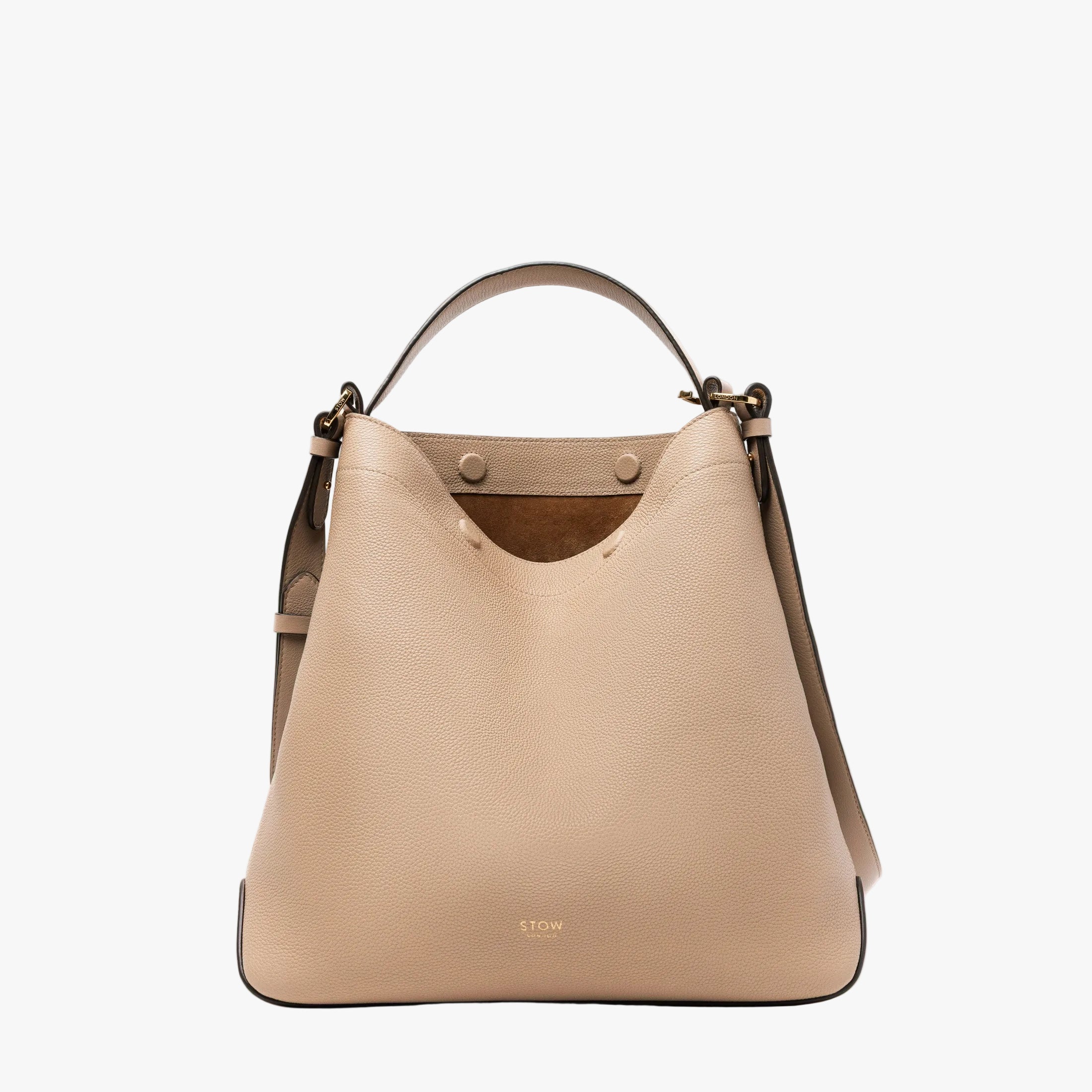 STOW London's Curve bag in Camel pebbled leather featuring gold-coated stainless steel hardware on a light grey background