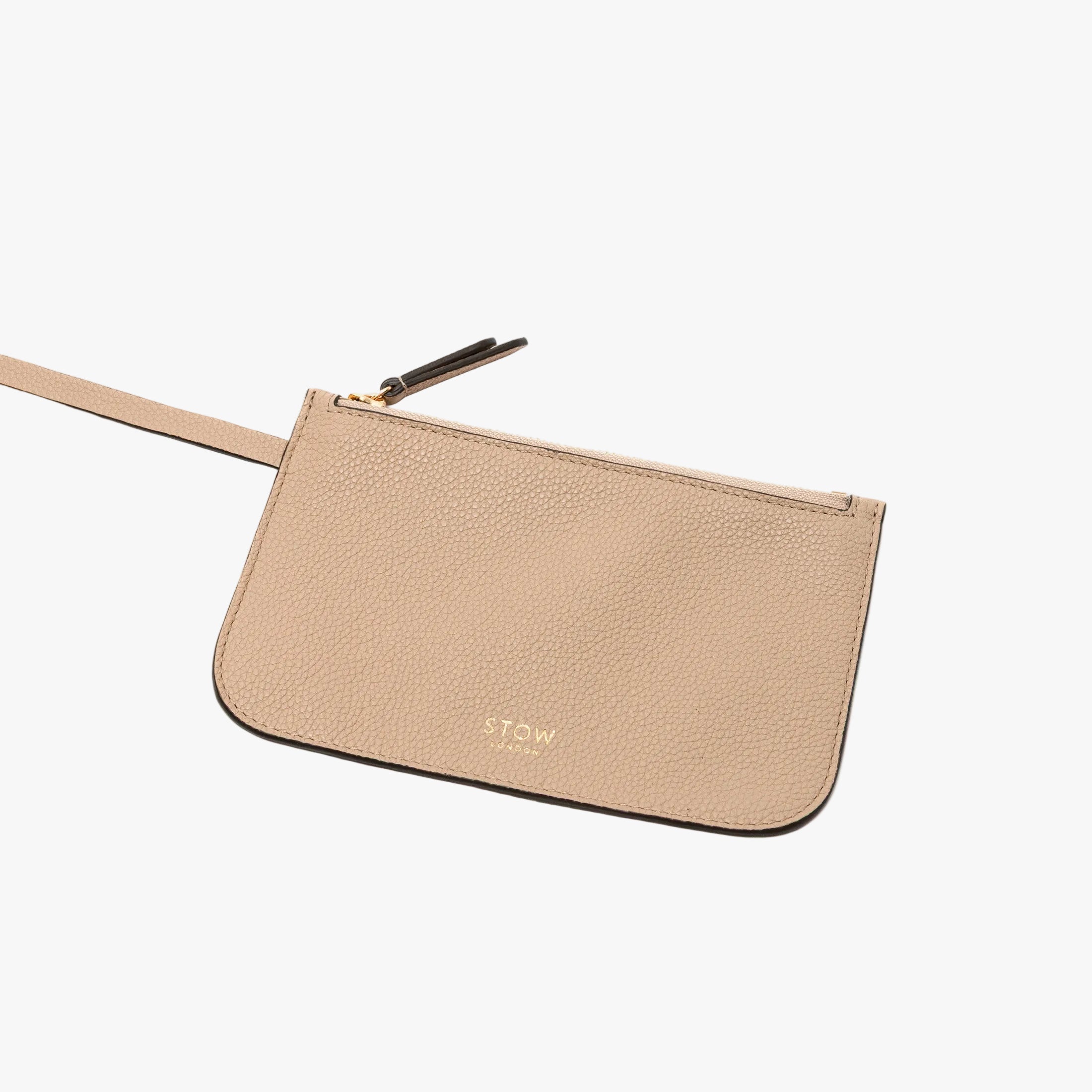 The Camel detachable interior zip pouch from STOW London's Curve bag featuring gold-coated stainless steel hardware and embossed logo on a light grey background