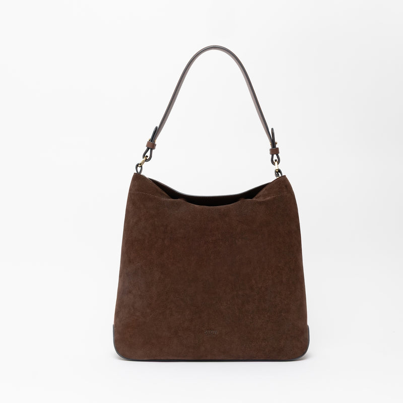 STOW London's Curve in Black leather on a light grey background featuring the detachable shoulder strap with gold hardware and details 