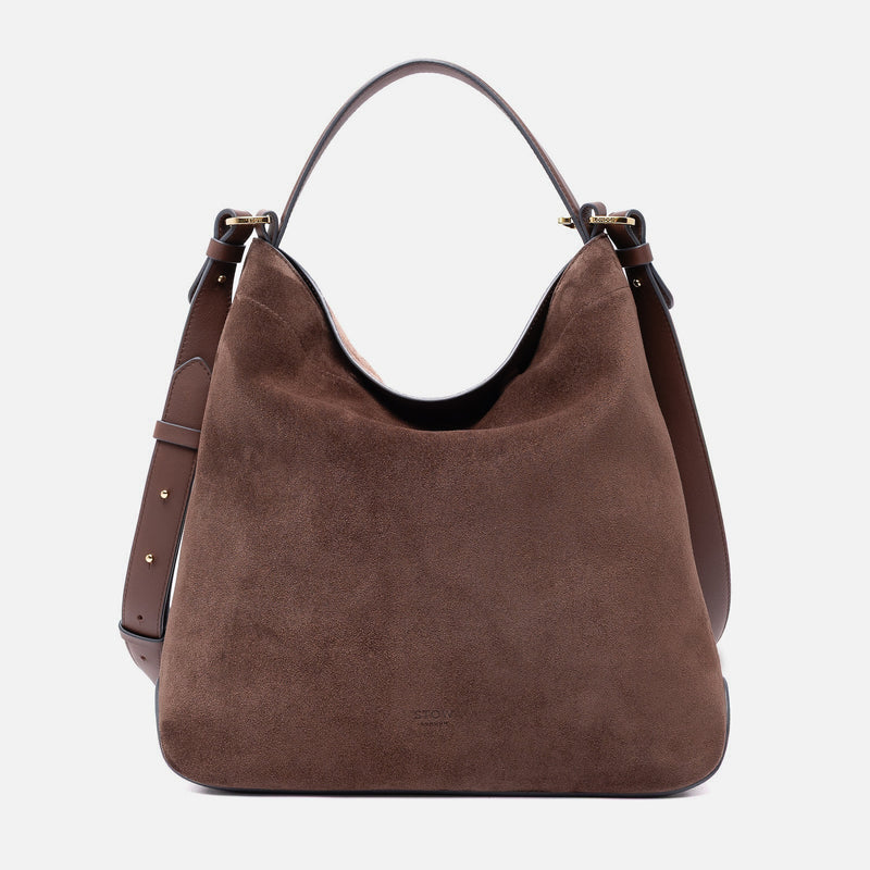 Stow London's Curve bag in Chocolate suede leather featuring gold-coated stainless steel hardware on a light grey background