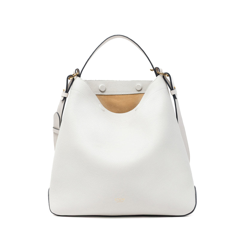 Stow London's Curve bag in Cloud Grey pebbled leather with magnets open showing cognac suede interior featuring gold-coated stainless steel hardware on a light grey background