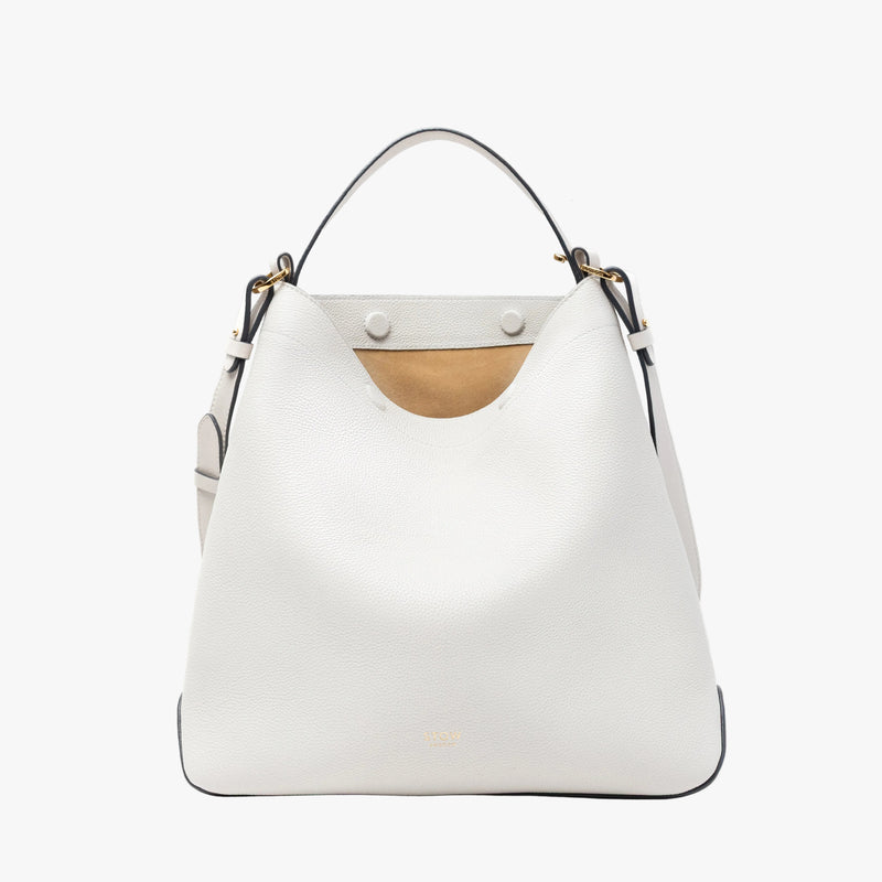 STOW London's Curve bag in Cloud Grey pebbled leather featuring the suede interior lining, concealed magnets, cgold-coated stainless steel hardware on a light grey background