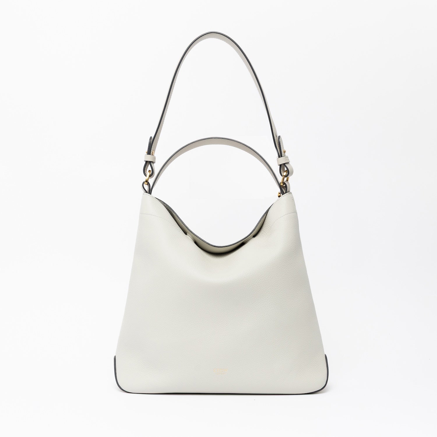 STOW London's Curve in Cloud Grey leather on a light grey background featuring the detachable shoulder strap and top handle with gold hardware and details 