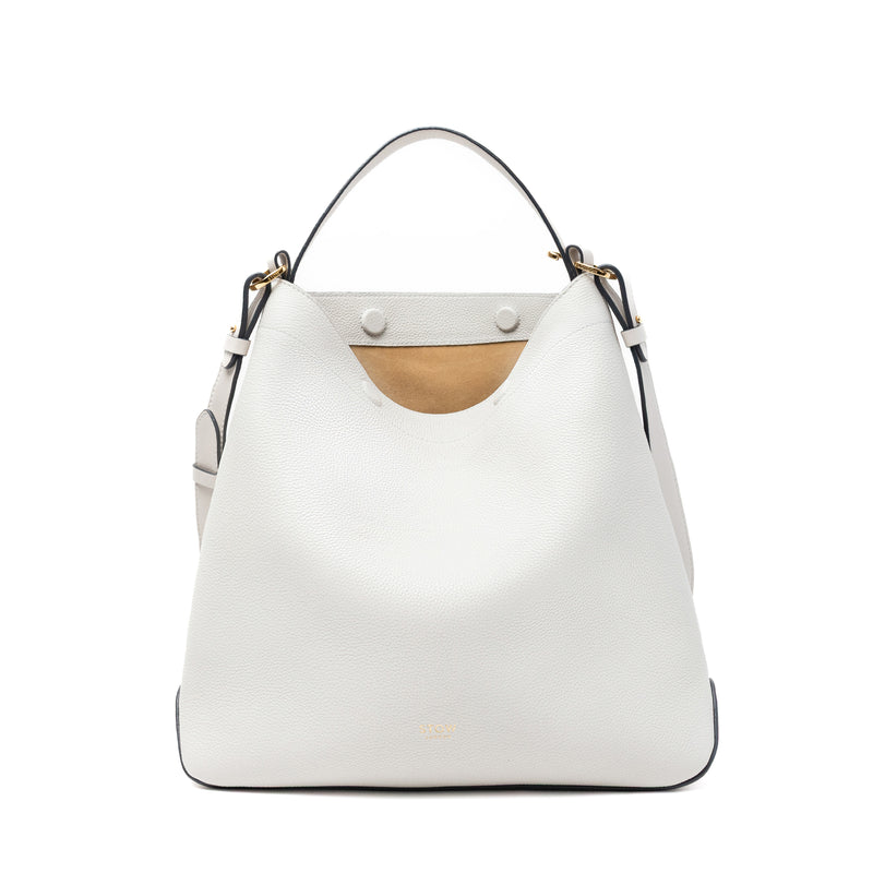 Stow London's Curve bag in Cloud Grey pebbled leather with magnets open showing cognac suede interior featuring gold-coated stainless steel hardware on a light grey background