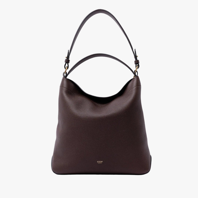 STOW London's Curve Bag in Espresso pebbled leather on a light grey background featuring the detachable shoulder strap and gold-coated stainless steel hardware