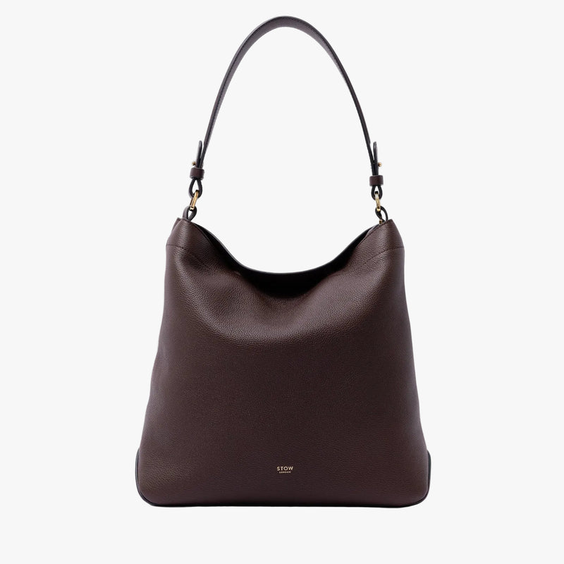 STOW London's Curve Bag in Espresso pebbled leather on a light grey background featuring the detachable shoulder strap and gold-coated stainless steel hardware