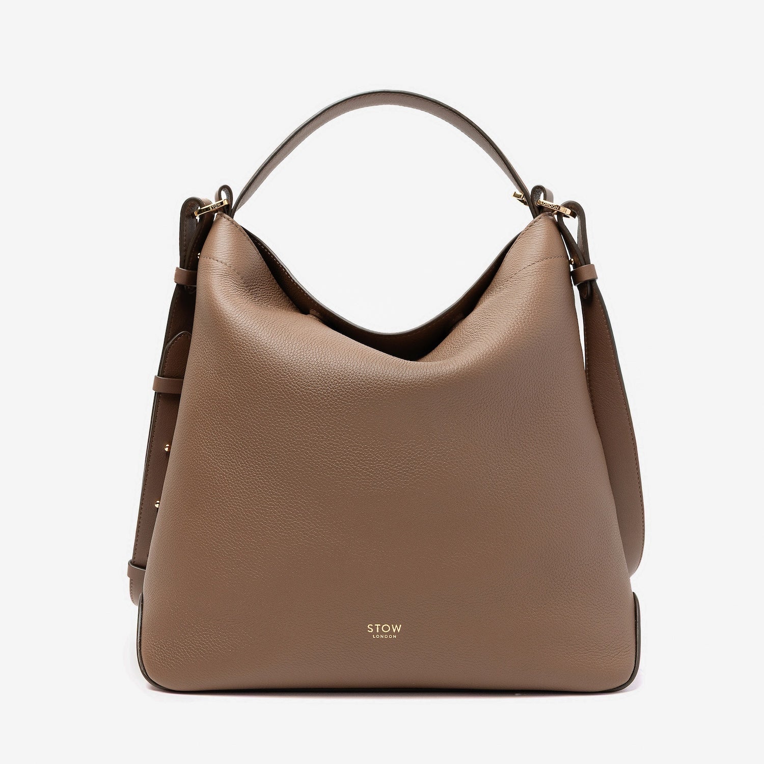 STOW London's Curve bag in Mocha pebbled leather featuring gold-coated stainless steel hardware on a light grey background