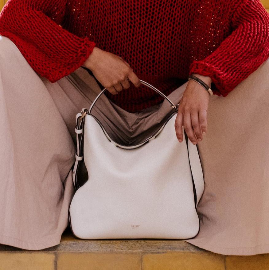 STOW London Curve Bag in Spring Moon leather held by model in Tangiers photo shoot.