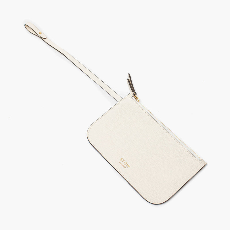 Close up of the detachable interior pouch of Stow London's Curve bag in Spring Moon pebbled leather on a light grey background